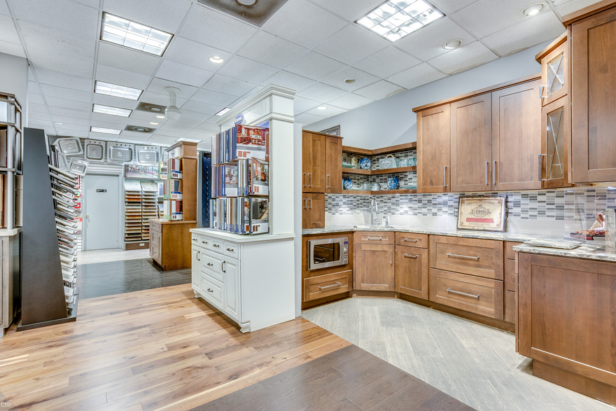 Consumers Supply kitchen showroom featuring rustic cabinets