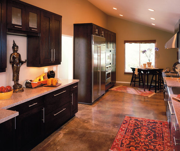 Small kitchen with dark wood cabinets and marble countertops