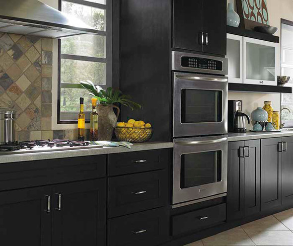Kitchen with black wooden cabinets and a double oven