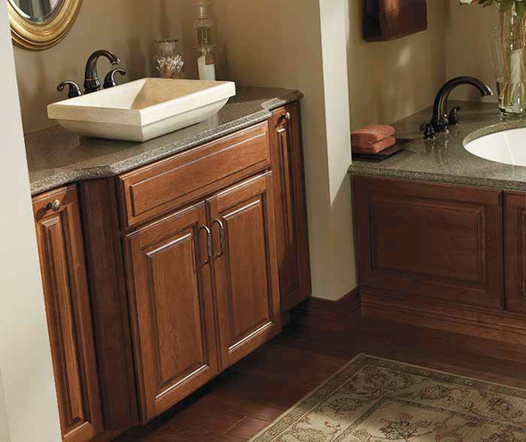 Traditional wooden bathroom cabinets and grey countertops with vessel sink
